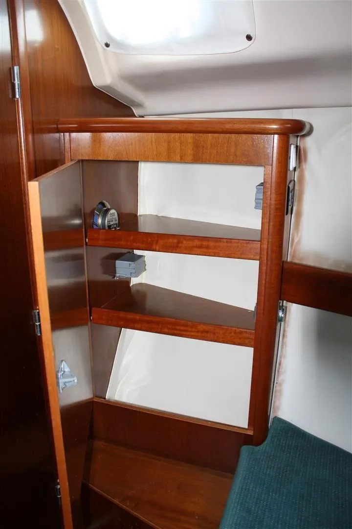 Slide: The Image of Wooden shelving inside a 1999 Beneteau Oceanis 352 sailboat cabin. - 16