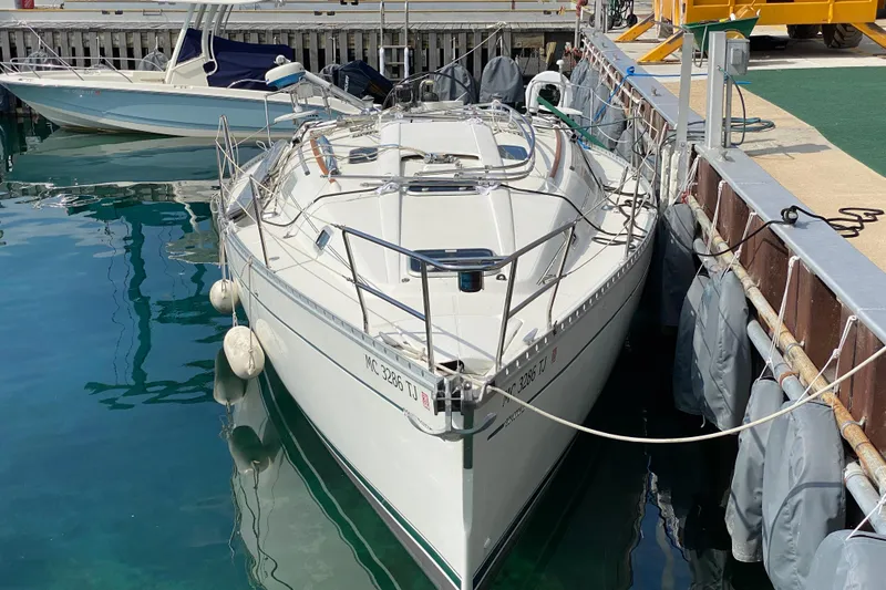 Slide: The Image of 1999 Beneteau Oceanis 352 sailboat docked at marina, calm water reflection. - 2