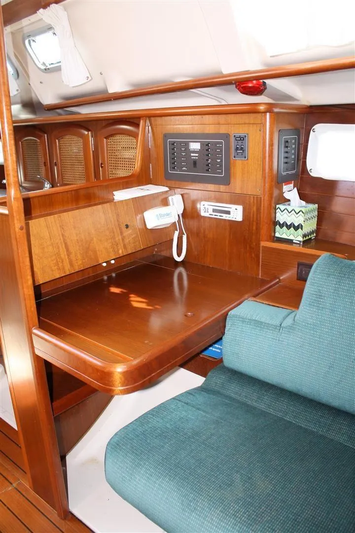 Slide: The Image of Interior of 1999 Beneteau Oceanis 352 sailboat with navigation station and seating area. - 25