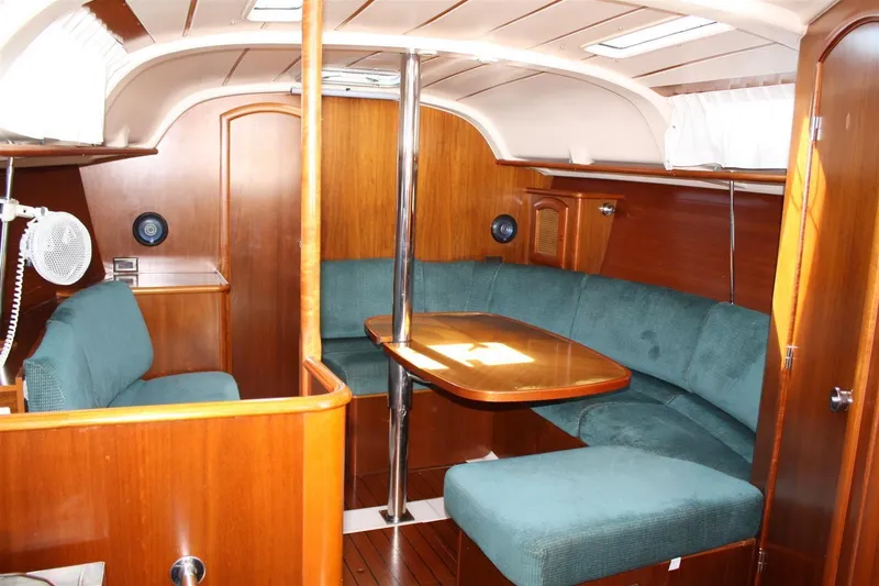 Slide: The Image of Interior of 1999 Beneteau Oceanis 352 sailboat with wood finish and green seating. - 27