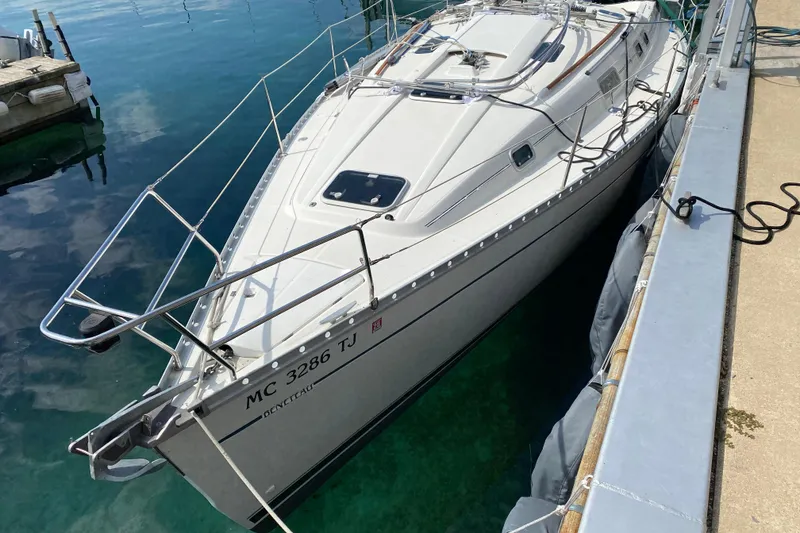 Slide: The Image of 1999 Beneteau Oceanis 352 sailboat docked in clear water, side view. - 3