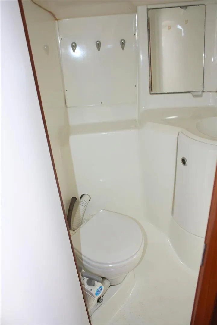 Slide: The Image of 1999 Beneteau Oceanis 352 yacht bathroom with white fixtures and compact design. - 30