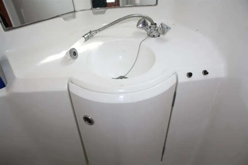 Slide: The Image of White bathroom sink on 1999 Beneteau Oceanis 352 yacht, featuring a modern faucet design. - 31