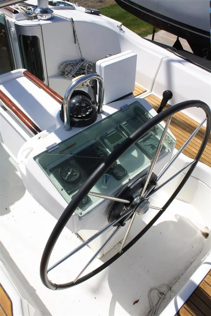 Slide: The Image of 1999 Beneteau Oceanis 352 sailboat cockpit with steering wheel and navigation instruments. - 6