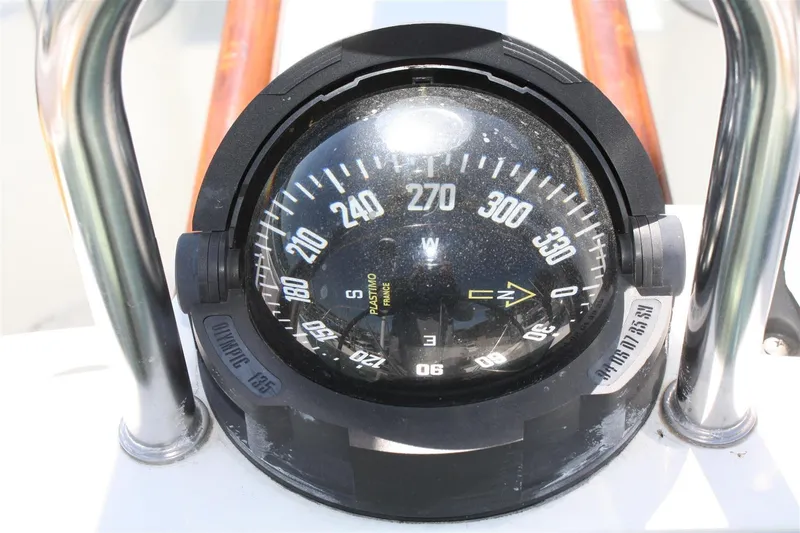 Slide: The Image of Compass on 1999 Beneteau Oceanis 352 sailboat, displaying navigational directions. - 9