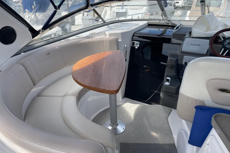 Slide: The Image of 2011 Regal 3060 Express Cruiser interior with canopy, docked at marina. - 15