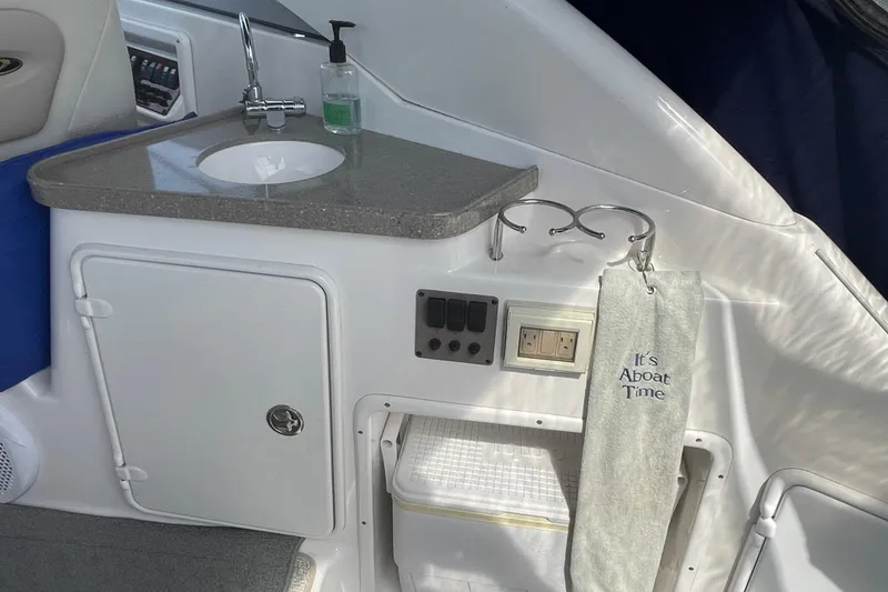 Slide: The Image of 2011 Regal 3060 Express Cruiser interior with curved seating and wooden table. - 16