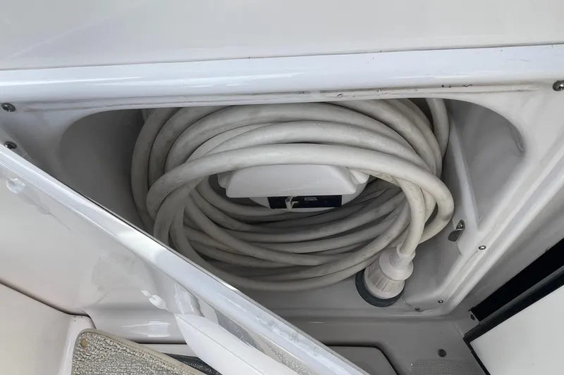 Slide: The Image of 2011 Regal 3060 Express Cruiser interior with sink, towel, and storage cabinet. - 17