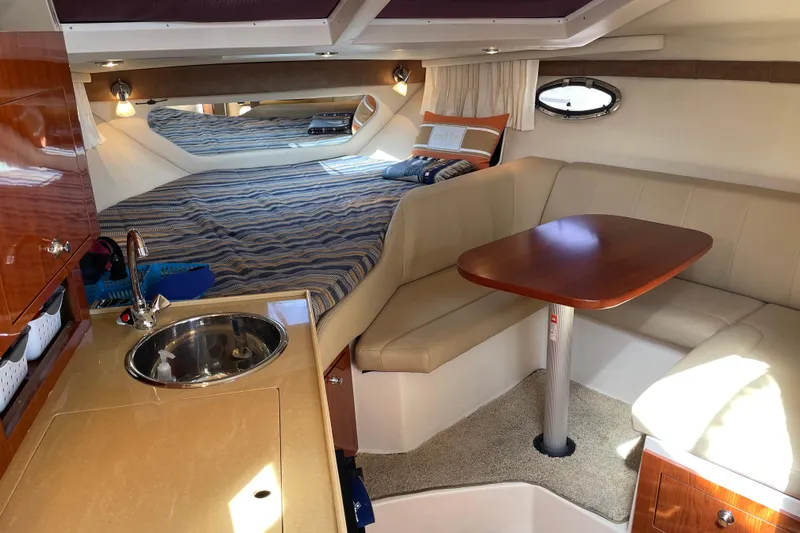 Slide: The Image of Luxurious interior of 2011 Regal 3060 Express Cruiser with cozy seating and kitchenette. - 21