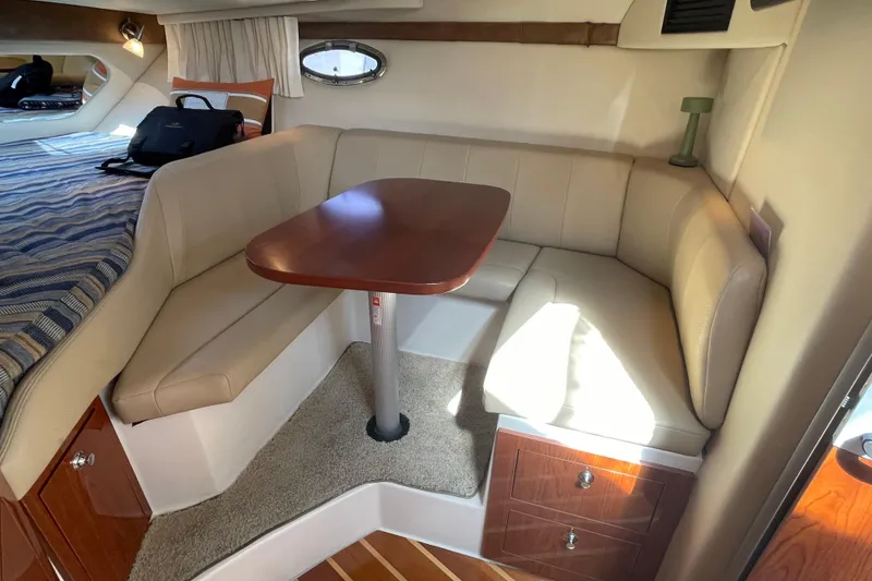 Slide: The Image of Interior cabin of 2011 Regal 3060 Express Cruiser with cozy bed and seating area. - 22