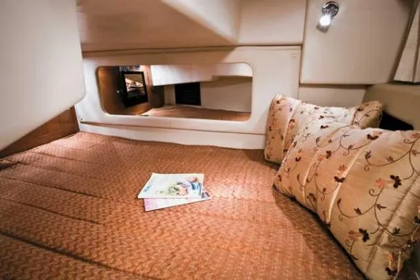 Slide: The Image of Luxurious interior of 2011 Regal 3060 Express Cruiser with kitchenette and seating area. - 23