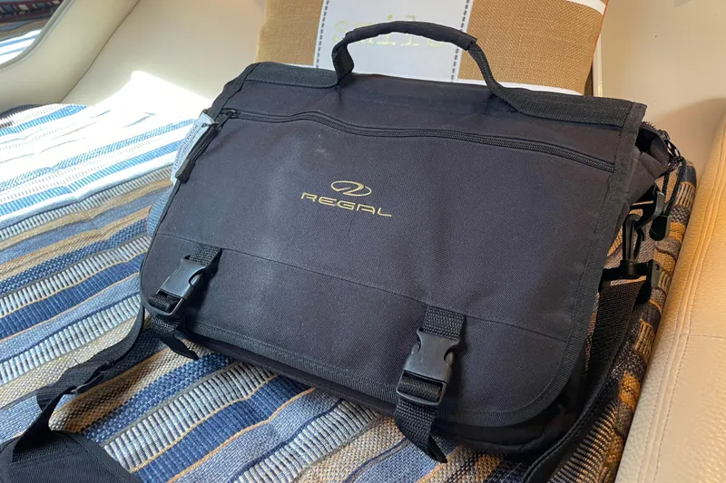 Slide: The Image of Black Regal branded bag on a striped seat inside a 2011 Regal 3060 Express Cruiser. - 34