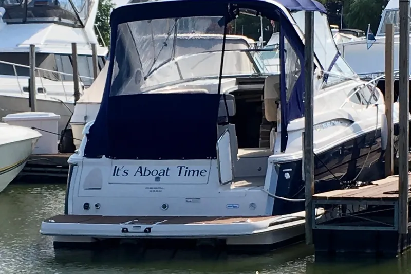 Slide: The Image of 2011 Regal 3060 Express Cruiser docked with blue canopy, named "It's Aboat Time". - 39