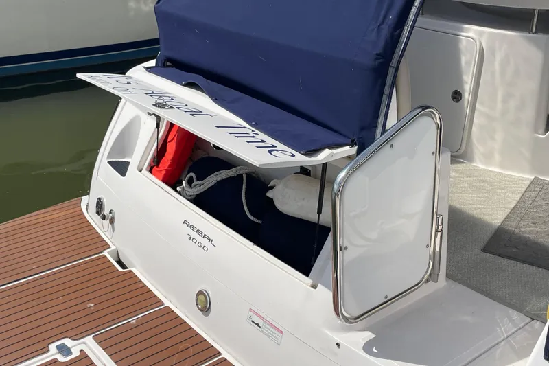 Slide: The Image of 2011 Regal 3060 Express Cruiser with open storage compartment on deck. - 40