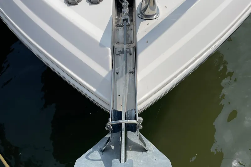 Slide: The Image of Bow of 2011 Regal 3060 Express Cruiser with anchor, docked on calm water. - 41