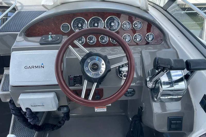 Slide: The Image of 2011 Regal 3060 Express Cruiser docked at marina, featuring sleek design and blue accents. - 5