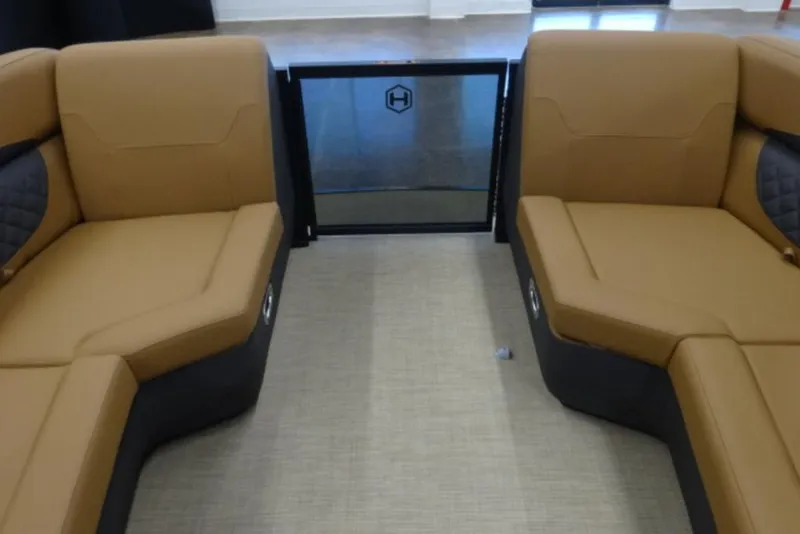 Slide: The Image of 2026 Harris Sunliner 250 interior with tan seating and modern design. - 15