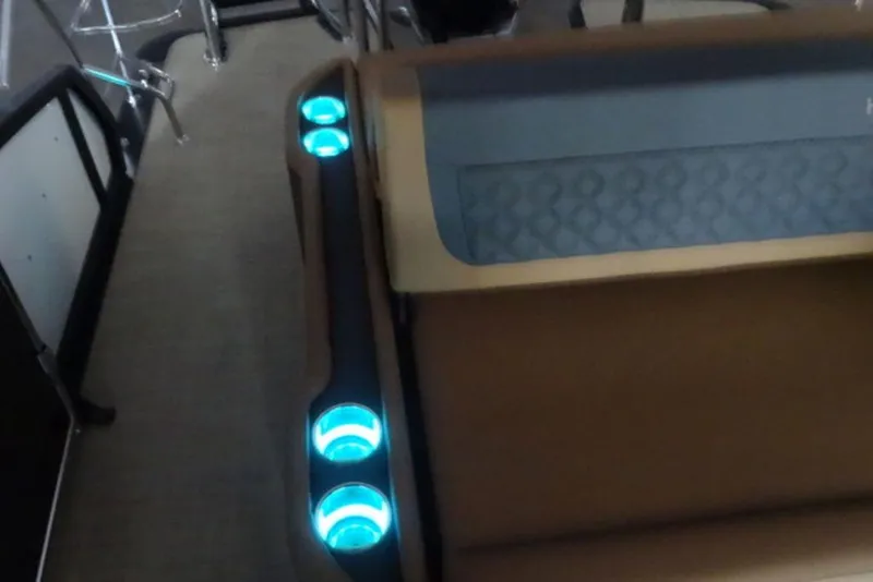 Slide: The Image of 2026 Harris Sunliner 250 interior with illuminated cup holders and stylish seating. - 16