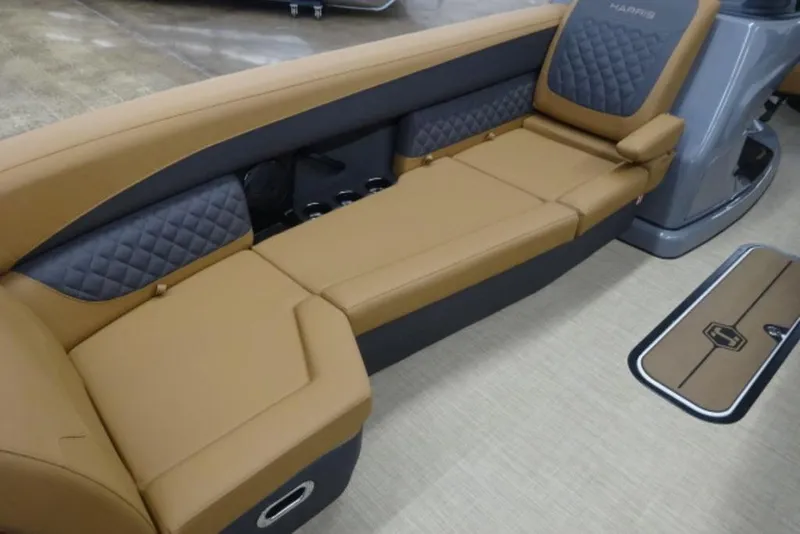 Slide: The Image of Luxurious seating on 2026 Harris Sunliner 250 pontoon boat, featuring tan and gray upholstery. - 2