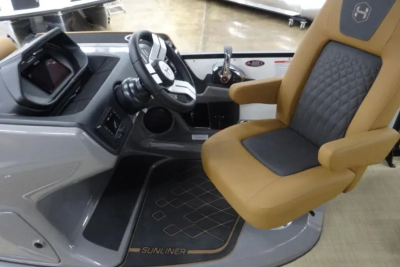 Slide: The Image of 2026 Harris Sunliner 250 helm with tan captain's chair and modern dashboard controls. - 8