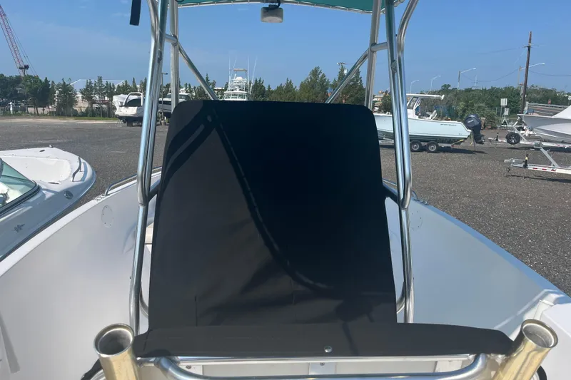 Slide: The Image of 2006 Seaquest 2200 BW boat with black seat cover, parked outdoors. - 6