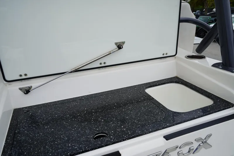 Slide: The Image of 2020 Sea Fox 328 Commander boat with open storage compartment and speckled countertop. - 16