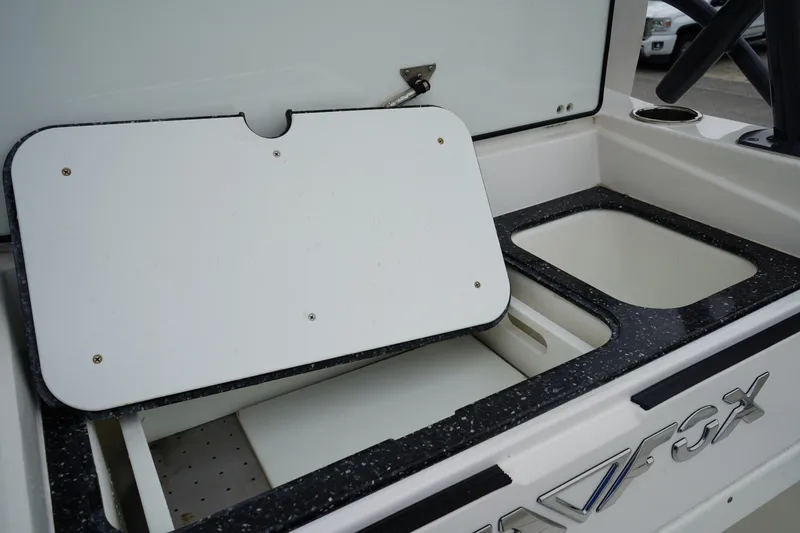 Slide: The Image of 2020 Sea Fox 328 Commander boat storage compartments and cutting board. - 17