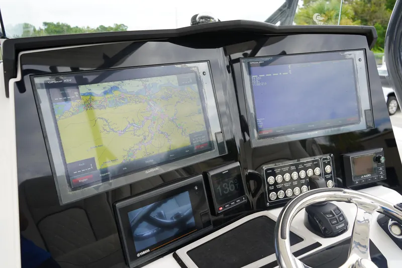 Slide: The Image of 2020 Sea Fox 328 Commander dashboard with dual Garmin displays and navigation controls. - 35