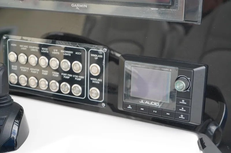 Slide: The Image of Control panel of 2020 Sea Fox 328 Commander with JL Audio system and various switches. - 39