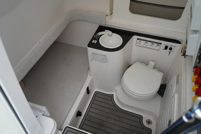 Slide: The Image of 2020 Sea Fox 328 Commander boat bathroom with toilet and sink. - 48