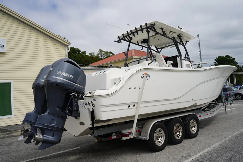 Slide: The Image of 2020 Sea Fox 328 Commander boat on trailer with Yamaha engines, parked outdoors. - 5