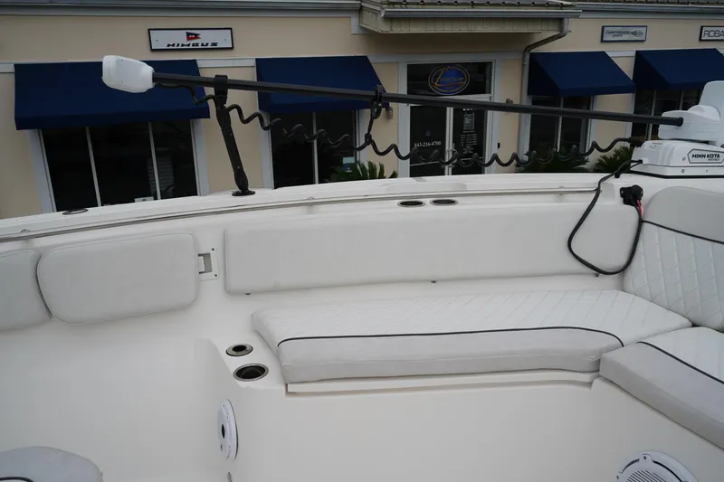 Slide: The Image of 2020 Sea Fox 328 Commander boat interior with white cushioned seating and fishing rod holder. - 59