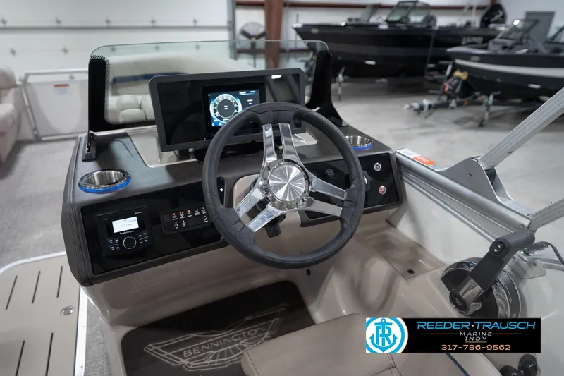 Slide: The Image of 2026 Bennington 22 ML boat dashboard with steering wheel and digital display. - 100