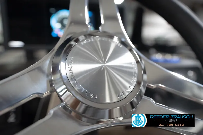 Slide: The Image of Close-up of 2026 Bennington 22 ML steering wheel with Reeder-Trausch Marine logo. - 101