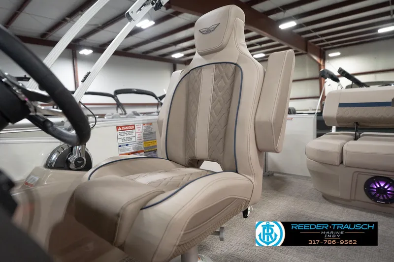 Slide: The Image of 2026 Bennington 22 ML boat interior with luxurious beige seating and steering wheel. - 107
