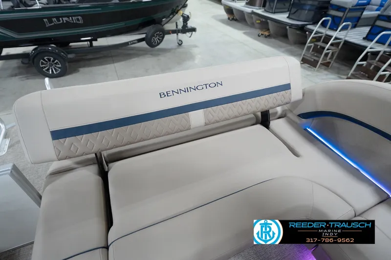 Slide: The Image of 2026 Bennington 22 ML boat interior with beige seating and blue accents. - 110