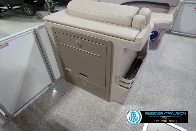 Slide: The Image of 2026 Bennington 22 ML boat interior with beige seating and storage compartment. - 90