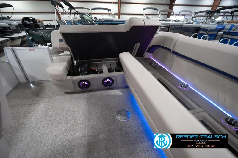 Slide: The Image of 2026 Bennington 22 ML boat interior with open storage, LED lighting, and speaker system. - 95