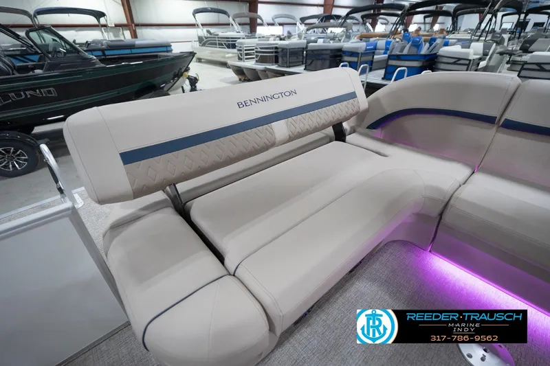 Slide: The Image of 2026 Bennington 22 ML boat interior with beige seating and ambient lighting. - 96
