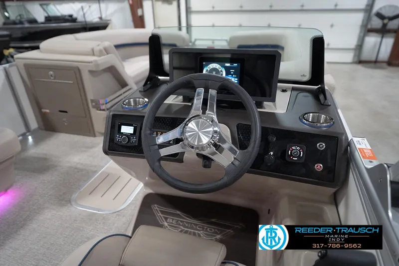 Slide: The Image of 2026 Bennington 22 ML boat dashboard with steering wheel and digital display. - 99