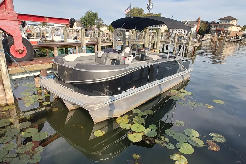 The Image of 2023 Tahoe Pontoon LTZ Rear Fish 22' docked, featuring sleek design and canopy. - 0