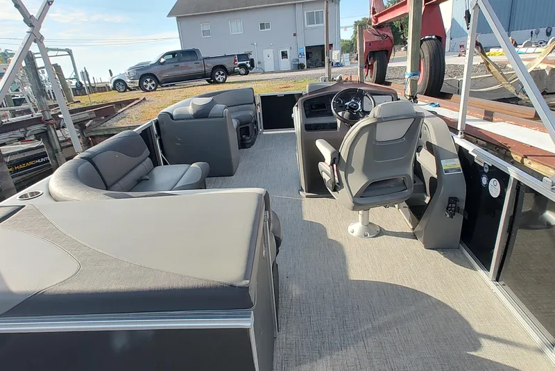 Slide: The Image of 2023 Tahoe Pontoon LTZ Rear Fish 22' interior with seating and steering console. - 10