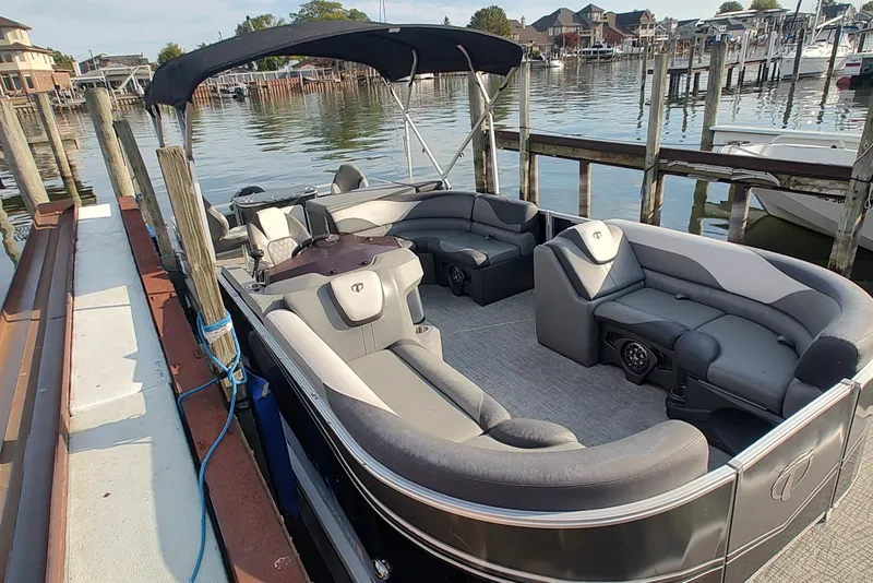 Slide: The Image of 2023 Tahoe Pontoon LTZ Rear Fish 22' docked, featuring spacious seating and sleek design. - 2