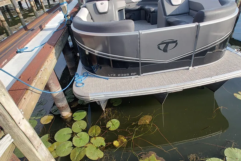 Slide: The Image of 2023 Tahoe Pontoon LTZ Rear Fish 22' docked, surrounded by water lilies. - 3