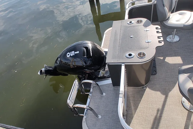Slide: The Image of 2023 Tahoe Pontoon LTZ Rear Fish boat with motor and fishing setup. - 6