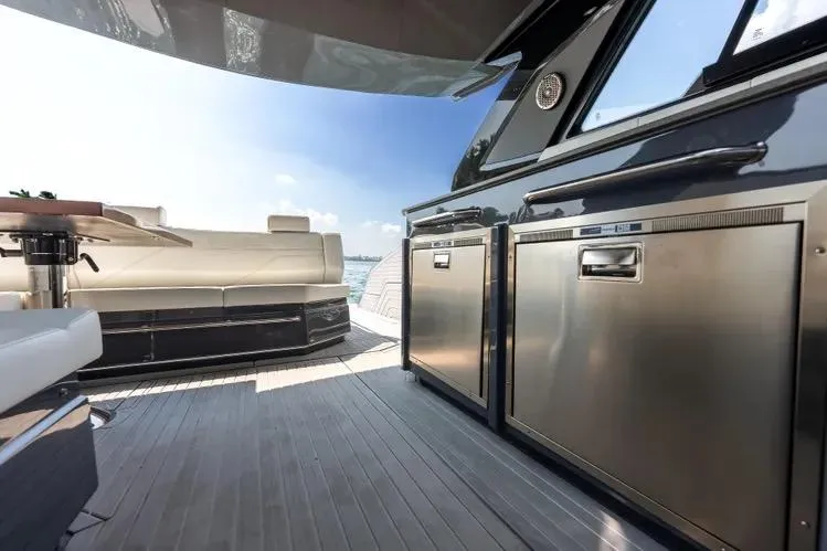Slide: The Image of 2023 Cruisers 42 GLS OB yacht interior with modern kitchen and seating area. - 17