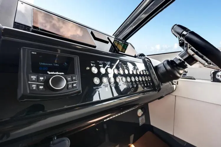 Slide: The Image of 2023 Cruisers 42 GLS OB dashboard with modern controls and steering wheel. - 24