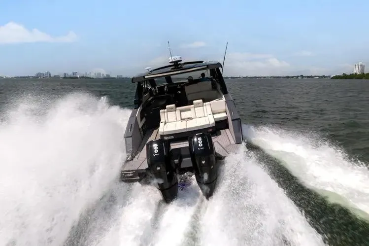 Slide: The Image of 2023 Cruisers 42 GLS OB speeding on open water, showcasing powerful outboard engines. - 4