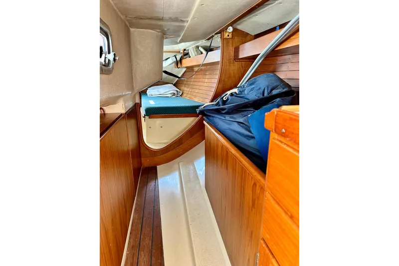 Slide: The Image of Interior of 1983 Sirena 38 sailboat with wooden cabinetry and cozy sleeping area. - 18