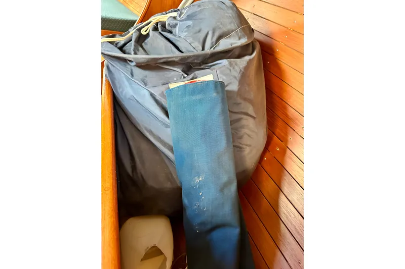 Slide: The Image of Interior of 1983 Sirena 38 sailboat with stored sails and wooden paneling. - 19